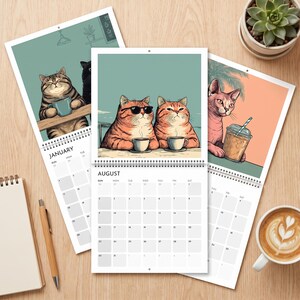 May include: A wall calendar featuring illustrations of cats with beverages. The center page shows two orange tabby cats with coffee, one wearing sunglasses. The left page shows a cat with a mug, and the right page shows a cat with an iced drink.