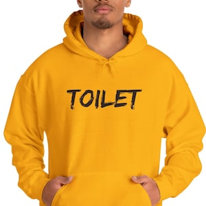 May include: A yellow hooded sweatshirt with the word "TOILET" printed in black on the front.