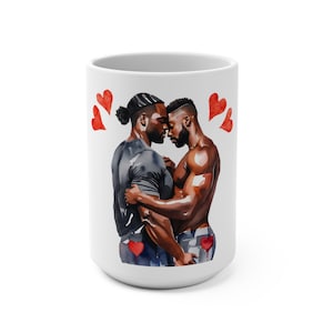 May include: White ceramic mug with a watercolor illustration of two men embracing. The men are Black and have short hair. The illustration is surrounded by red hearts.