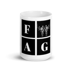May include: White ceramic mug with a black and white design. The design features the letters "FAG" in a grid pattern, with a graphic of two angels in the center square.