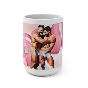 May include: White ceramic mug with a watercolor illustration of two men embracing in front of pink balloons. The men are wearing underwear and smiling.