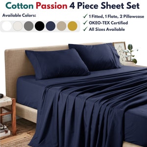 May include: A navy blue 4-piece cotton sheet set with a fitted sheet, flat sheet, and two pillowcases. The sheet set is available in multiple colors, is OKEO-TEX certified, and comes in all sizes.