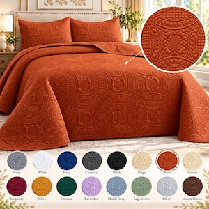 May include: A rust-colored bedspread and two matching pillow shams featuring an embossed geometric pattern of circles and floral motifs. A circular inset shows a detailed view of the quilted texture. A color chart displays sixteen options.
