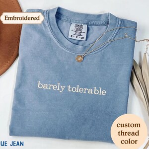 a blue t - shirt with the words barrelly tolerable on it
