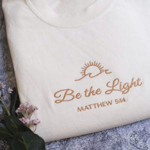 Embroidered Be The Light Matthew 5:14 Comfort Colors® Shirt | Inspirational Christian Tee | Religious Faith Clothing | Bible Verse Gifts