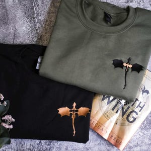 a couple of t - shirts sitting on top of a table