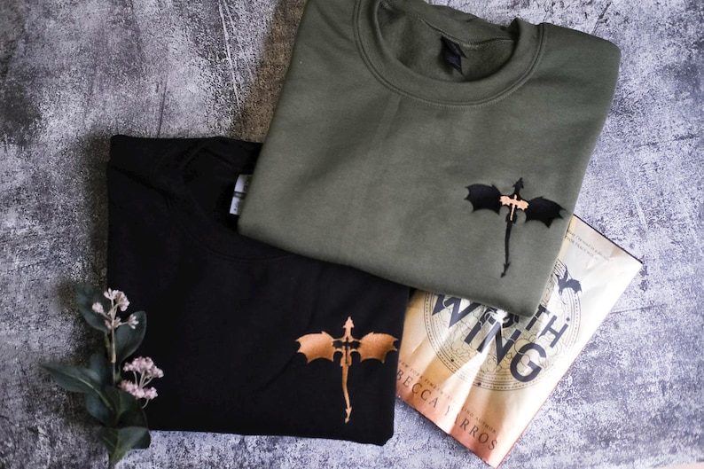 a couple of t - shirts sitting on top of a table