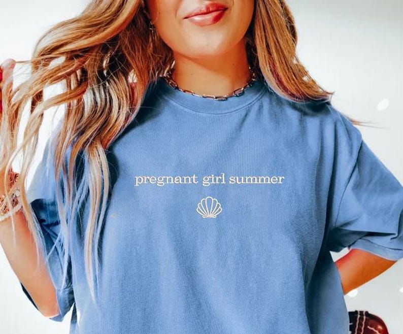 a woman in a blue shirt is posing for a picture