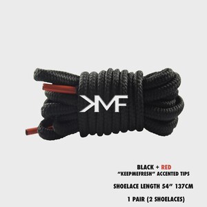 May include: Black shoelaces with red accented tips, coiled and ready for use. The text on the image reads "BLACK + RED", "KEEPMEFRESH" ACCENTED TIPS, SHOELACE LENGTH 54" 137CM, and 1 PAIR (2 SHOELACES).