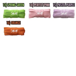 May include: Four spools of shoelaces in different colors: spring green, perfect pink, pastel purple, and orange. Each spool has the letters "MF" printed on it.