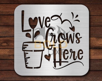 May include: A metal sign with the text "Love Grows Here" in a decorative font. The sign features a stylized plant in a pot with a heart-shaped flower.