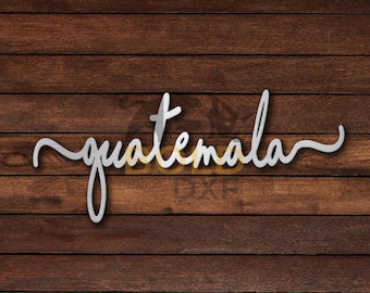 May include: A white cursive word "guatemala" on a brown wood background.