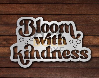 May include: White metal sign with the text "Bloom with kindness" in a stylized font. The text is surrounded by small flower designs.