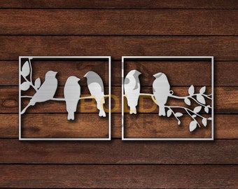 May include: Two metal wall art pieces featuring a silhouette of birds perched on a branch. The birds are in a row, facing the right. The branch has leaves. The art pieces are in a square frame.