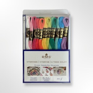 May include: A pack of 24 DMC embroidery floss skeins in a rainbow of colours. The pack is labelled "Vitamines | Vitamins | A Todo Color" and includes 4 metres (4.4 yards) of floss per skein.