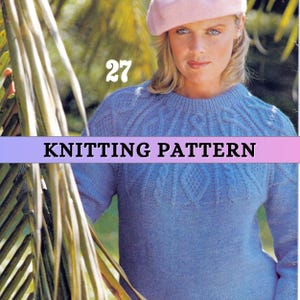 May include: A woman wearing a light blue knitted sweater and a pink beret. The sweater has a cable knit design across the chest. The text "KNITTING PATTERN" is displayed on a banner across the image, with the number "27" above it.