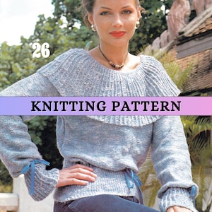 May include: A pale blue knitted sweater with a frilled collar and cuffs, adorned with blue ribbon ties. The image displays the text "KNITTING PATTERN" and the number "26". The sweater has long sleeves and a fitted waist.