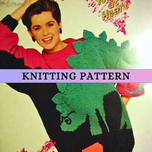 May include: Knitting pattern for a black and green sweater with a dinosaur design. The pattern includes instructions for knitting the sweater and the dinosaur design.