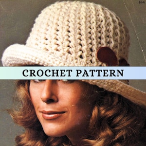 May include: A crochet pattern for a white crocheted hat with a brown button. The hat has a wide brim and a crocheted design.