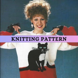 May include: Knitting pattern for a white sweater with a black cat design. The cat has green eyes and a white patch on its chest. The sweater has red sleeves and a red band at the bottom.