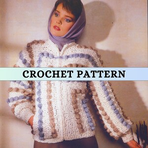 May include: A white crocheted jacket with brown and blue stripes and bobbles. The jacket has a zipper closure and pockets. CROCHET PATTERN is written across the image.