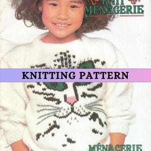 May include: Knitting pattern for a white sweater with a green-eyed cat face design. The pattern is from "Knit & Menagerie, Vol. 1".