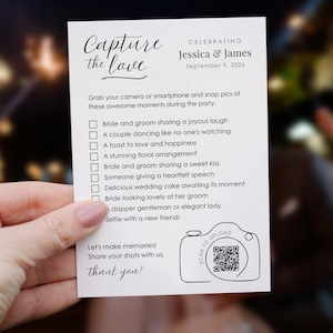 May include: A white card with black text that reads "Capture the love" and "Celebrating Jessica & James September 9, 2026". The card features a list of wedding moments to photograph, such as "Bride and groom sharing a joyous laugh" and "A couple dancing like no one's watching". The card also includes a QR code and the text "Scan to upload".