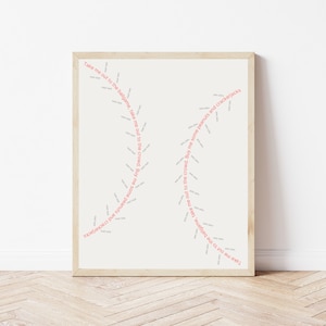 May include: A framed print with the text "Take me out to the ballgame, take me out to the crowd. Buy me some peanuts and crackerjacks" repeated in a spiral pattern.