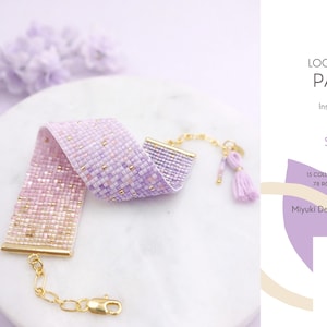 May include: A beaded loom bracelet in pink and lavender, with gold accents and a gold clasp. The bracelet is 2.03 cm wide and 13.5 cm long. The image text reads "LOOM BRACELET PATTERN" and "SYRIENNE".