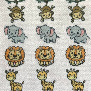 May include: A sheet of iron-on transfer paper with a variety of cute animal designs. The designs include a tiger, monkey, elephant, lion, giraffe, and zebra. The animals are all in a cartoon style and are brightly colored.