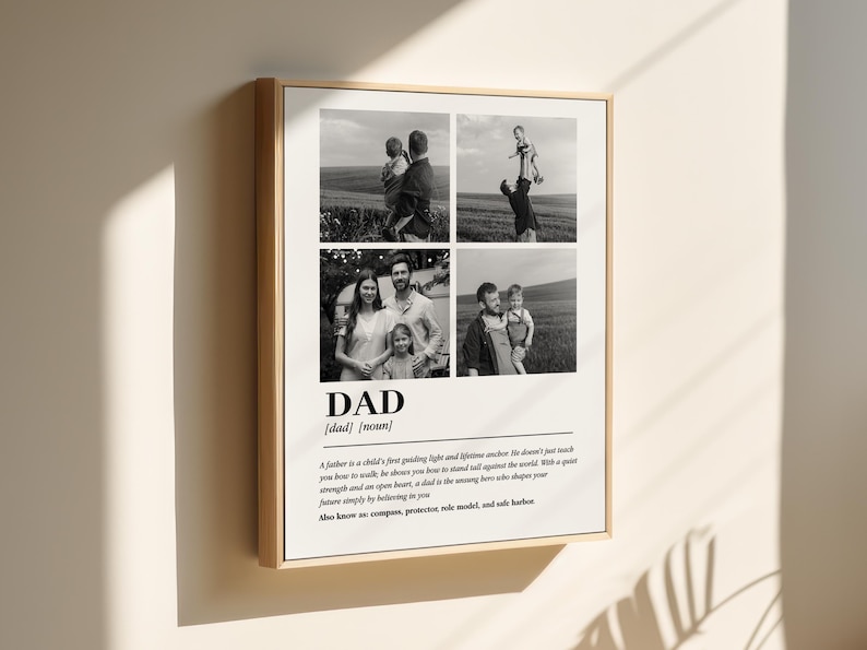 May include: Framed black and white print featuring four family photos. The word "DAD" is prominently displayed with a definition below. The print is in a light wood frame and hangs on a neutral wall.