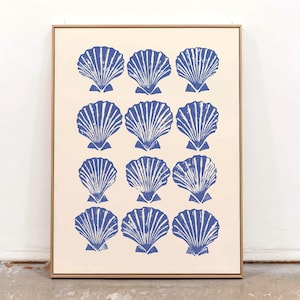 May include: A framed print featuring a repeating pattern of blue seashell illustrations on a cream background. The seashells are detailed with textured lines, and the frame is a natural wood color. The artwork is a coastal or nautical theme.