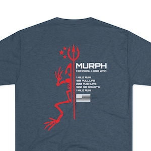 May include: A navy blue t-shirt with a red graphic on the back. The graphic includes the word "MURPH" above text listing a workout routine: 1 mile run, 100 pullups, 200 pushups, 300 air squats, and 1 mile run. An American flag is also included.