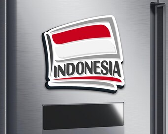 May include: A rectangular magnet featuring the Indonesian flag design. The flag is red and white, with the word "INDONESIA" in black lettering. The magnet has a white border and is displayed on a metallic surface.
