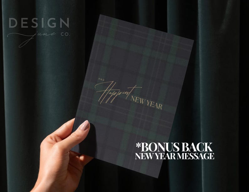 May include: A rectangular greeting card featuring a dark green and black plaid pattern. The text on the front reads "AND Happiest NEW YEAR" in a gold-colored script and serif font. The card includes a bonus back New Year message.