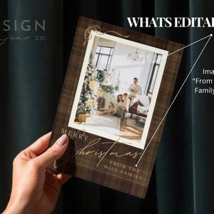 May include: A rectangular Christmas greeting card featuring a dark brown plaid background with a central white-bordered photo frame. The card displays the text Merry Christmas and FROM THE HILL FAMILY in a gold script and serif font combination.