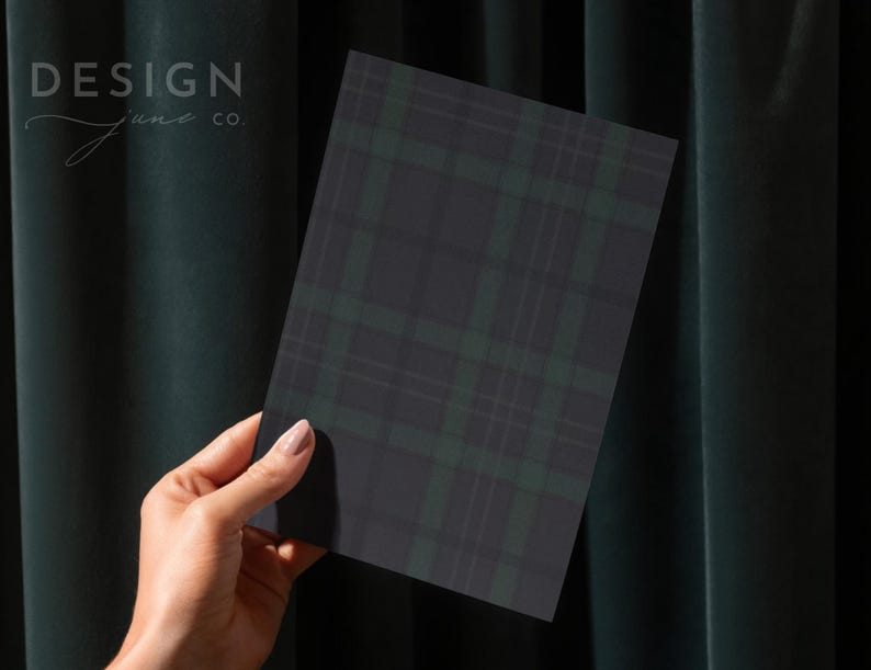May include: A rectangular card featuring a dark charcoal gray and forest green plaid pattern. The text DESIGN june co. is printed in the upper left corner of the card. The card has a smooth, matte finish and sharp, clean edges.