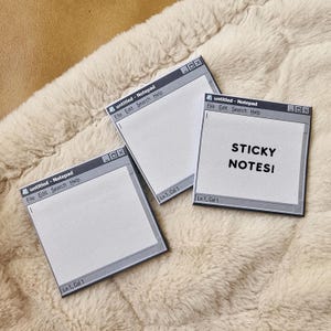 May include: Three square sticky notes designed to resemble a computer notepad application window. Each note features a grey title bar with the text "untitled - Notepad" and menu options, with one note displaying the black text "STICKY NOTES!" in the center.