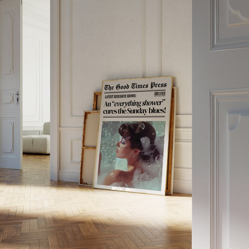 May include: A framed print of a vintage newspaper article with the headline "The Good Times Press" and the subheading "LATEST RESEARCH SHOWS: An "everything shower" cures the Sunday blues!" The image shows a woman in a bathtub with bubbles.