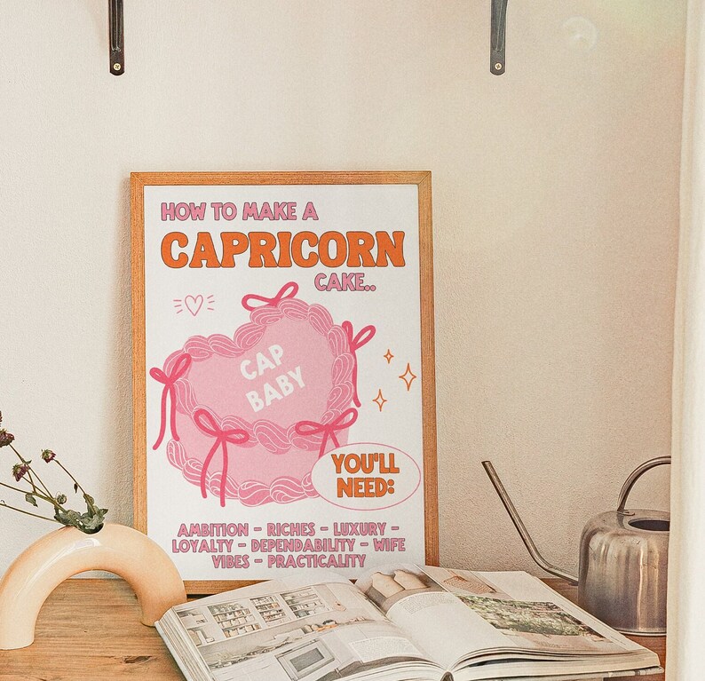 May include: A pink and orange illustrated poster with the text "How to make a Capricorn cake."  The poster features a pink heart-shaped cake with the text "Cap Baby" inside. The poster also includes a list of ingredients needed to make the cake, including ambition, riches, luxury, loyalty, dependability, wife vibes, and practicality.