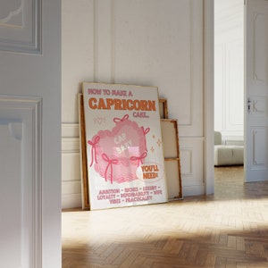 May include: A pink and white poster with the text "How to make a Capricorn cake."  The poster features a pink heart-shaped cake with the text "Cap Baby" inside. The poster also includes a list of ingredients needed to make the cake, including ambition, riches, luxury, loyalty, dependability, wife vibes, and practicality.