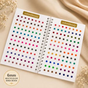 May include: A spiral-bound book containing rows of small, circular, multicoloured adhesive bindis. Each page features the text mehendi-beauty on a gold label. A circular graphic on the page indicates 6mm multicolour bindi book.
