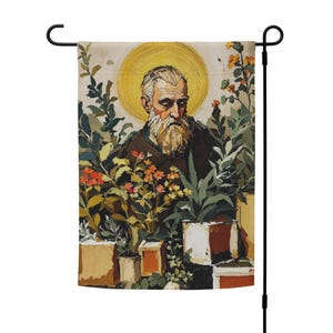 May include: A garden flag featuring a portrait of a man with a long white beard and a golden halo. The man is surrounded by lush green plants and colorful flowers in square pots. The flag is mounted on a black metal pole.