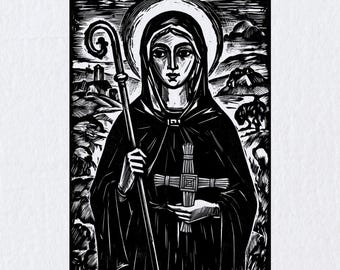 May include: A black and white woodcut-style print depicting a figure wearing a hooded cloak and a halo. The figure holds a tall staff in one hand and a woven cross in the other, set against a landscape background with hills and a small structure.