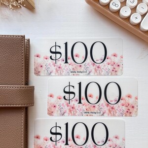 May include: Three gift cards with a floral design and the text "$100" and "Simply Budgeted".