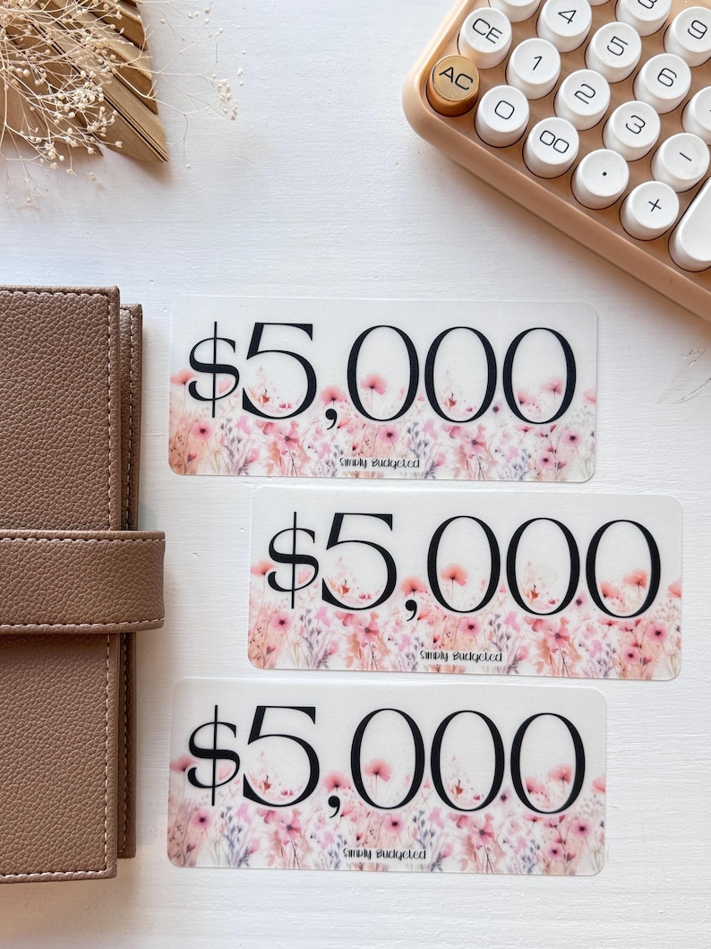 May include: Three transparent stickers with a floral design and the text "$5,000" and "Simply Budgeted".