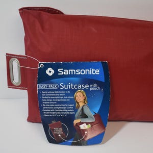 May include: Red Samsonite Easy-Pack Suitcase with pouch. The suitcase folds into a compact carry pouch. Opens to 20" x 14" x 13".