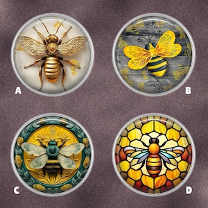 May include: Four round decorative bee-themed designs. One features a gold bee on a cream background. Another shows a yellow and black bee on a wood grain background. The third has a green and gold bee design. The last has a stained glass bee.