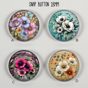 May include: Four 18mm snap buttons with floral designs. Button A features purple, pink, and blue flowers on a brown background. Button B has white flowers on a teal background. Button C displays pink flowers. Button D shows white and orange flowers on a yellow background. The text "SNAP BUTTON 18MM" is at the top.