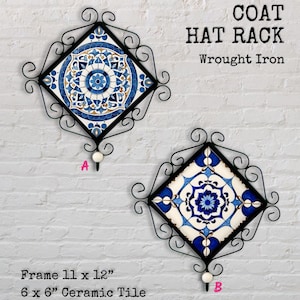 May include: Two wrought iron coat or hat racks with ceramic tiles. Each tile is 15 x 15 cm, set in a black frame that is 28 x 30 cm. The tiles have blue and white floral designs. The text "COAT HAT RACK" is visible.